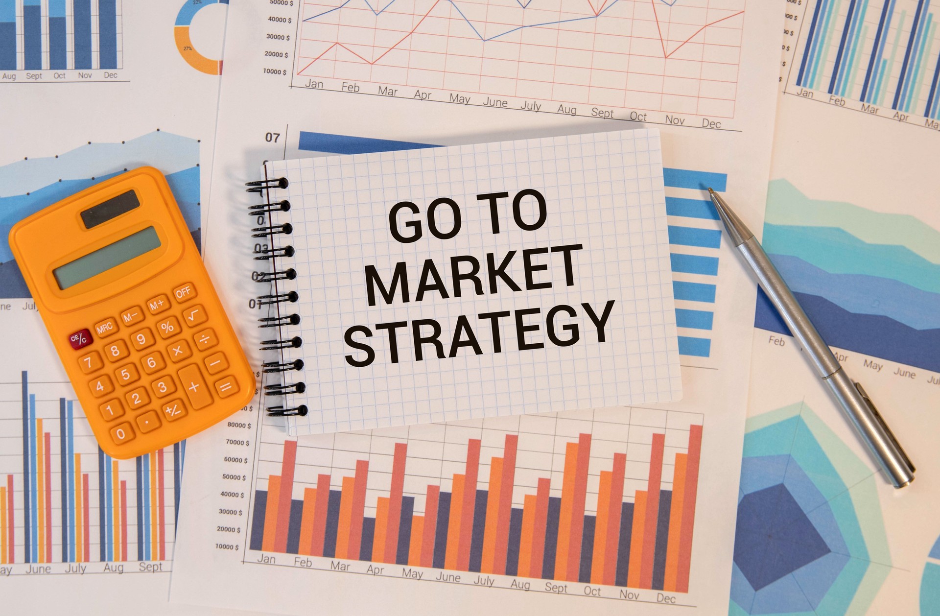 Business concept. On business reports there is a calculator and a sign with the inscription - Go to market strategy